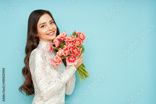 Wallpaper Mural Happy beauty woman with pink tulip bouquet on blue background. 8th of March celebration Torontodigital.ca