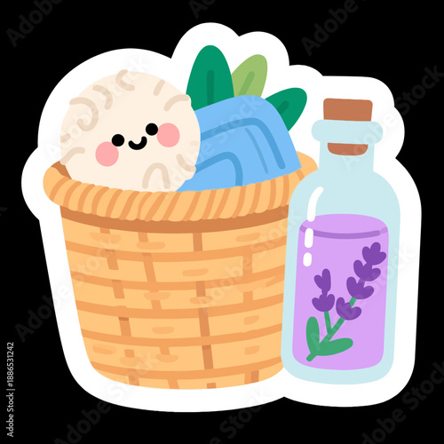 A cozy laundry basket filled with soft towels and a cute smiling ball of wool sits next to a glass bottle of lavender essential oil for a fresh aroma.