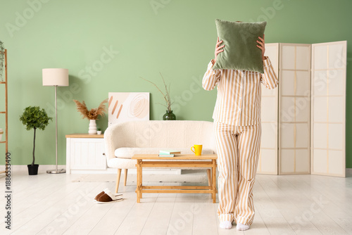 Young woman in pajamas with...