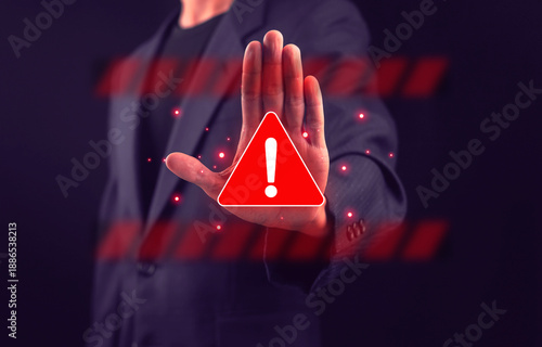 Valokuva Business professional showing stop hand gesture with warning alert symbol, representing cybersecurity threat, system access denied, risk prevention, digital security breach, online danger
