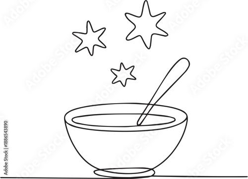 A bowl of soup with a spoon and stars above on a table top viewed from the side