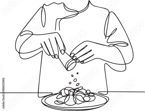 Chef seasoning a culinary dish with pepper on a plate