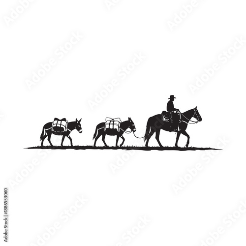 Cowboy riding horse leading two pack mules