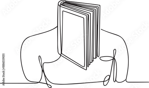 A person reading a book in a relaxed pose on a couch, viewed from the side.