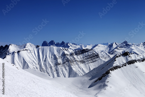 Off-piste slope in sun day and traces of avalanches, ski and sno