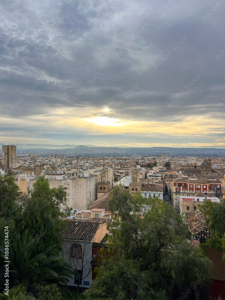 Fototapeta premium cityscape of Granada under a clear sky, highlighting its unique blend of Moorish and Spanish architecture that attracts visitors from around the world. Travel features, cultural documentaries