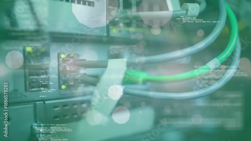 Animation of lens flares, circles, computer language against back panel of machinery and with wires