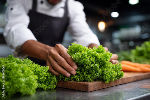 Chef cooks fresh greens in the kitchen