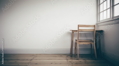 organized. A clean and simple office corner featuring a wooden desk and chair under soft natural light. real-estate listings.