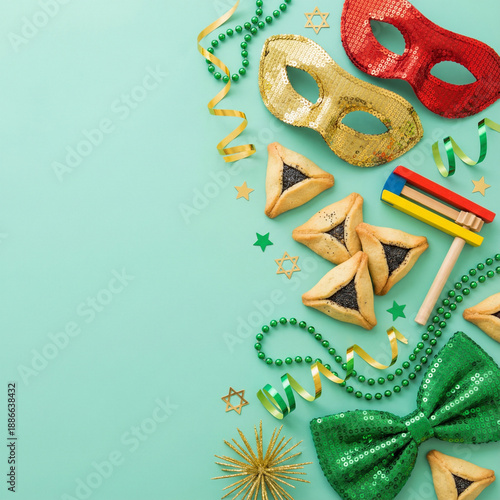 Wallpaper Mural Invitation to a Purim gala. Top view shot of triangular cookies, Star of David motifs, festive masquerade items, bow tie, beads, gragger on soft mint canvas with free space for text or advertisements Torontodigital.ca