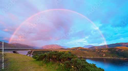 Rainbow arching over Kylesku Bridge in Scottish Highlands