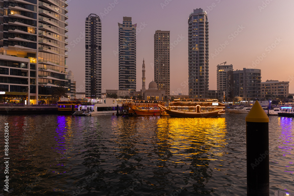 Obraz premium Night view of the city. Black and blue sky, lighting, and city streets. On the streets of the Emirates, in a public space.