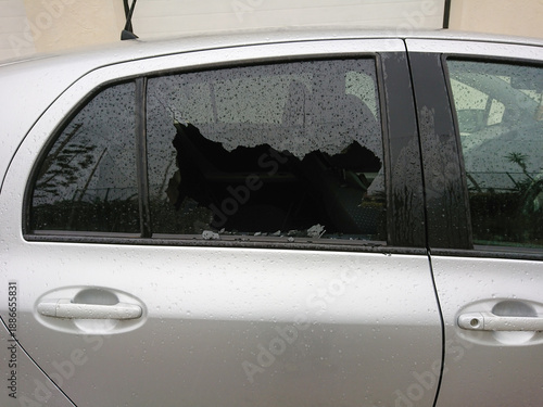 Wallpaper Mural Car break in shattered smashed side window on wet silver sedan. burglary surge tied to economic strain, theft risk rising across neighborhoods Torontodigital.ca