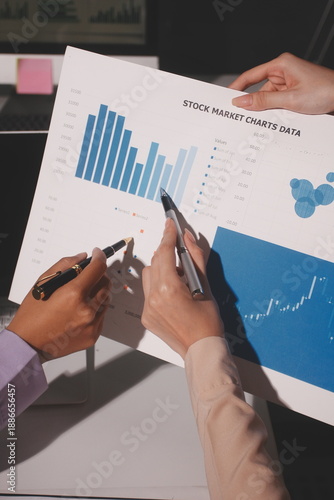 Above table with finance papers, graphs and big data during teamwork meeting with accounting or marketing team discussing budget, strategy or growth development. Closeup of SEO team doing research