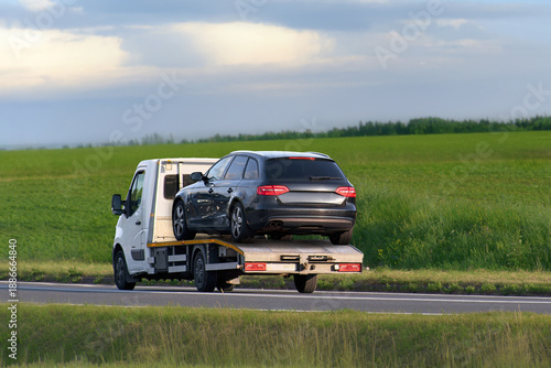 Tableau sur toile Car being towed by roadside assistance vehicle