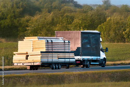 Фотография Black truck driving with construction materials
