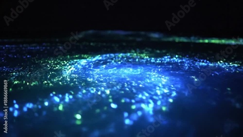 Wallpaper Mural Glowing blue particles illuminated in a dark environment viewed from a close-up perspective Torontodigital.ca