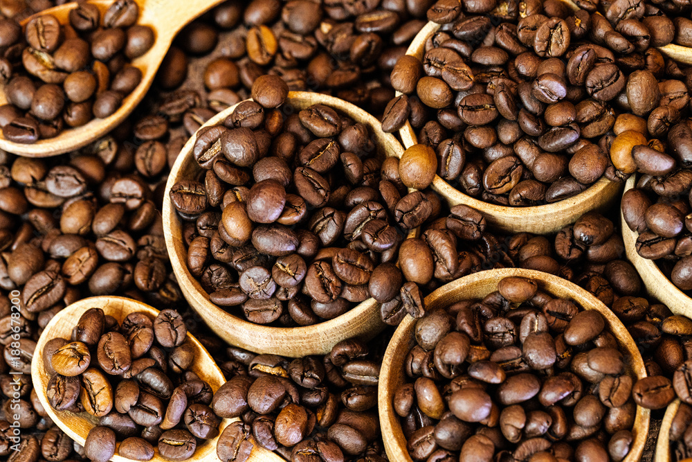 Fototapeta premium Coffee beans background with rich brown tones and natural texture. Roasted coffee beans close-up, creating a warm and aromatic backdrop ideal for coffee shops, cafes, menus, packaging, branding, food 