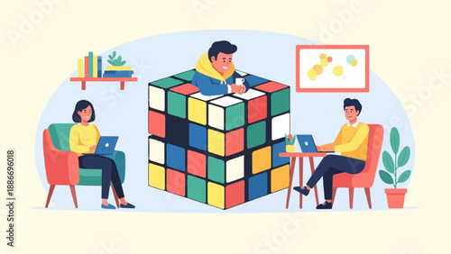 Three people work on laptops around a giant cube puzzle