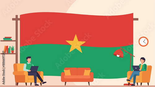 Two individuals relax on couches using laptops with a large flag backdrop