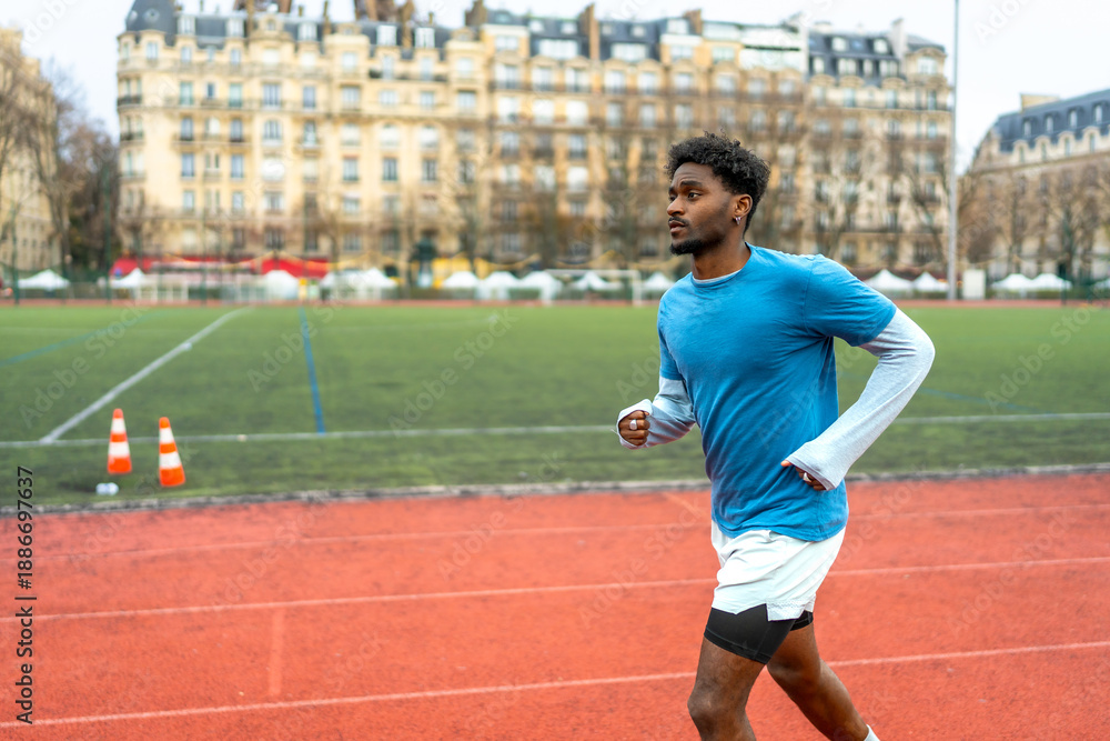 Obraz premium Young black man running track in paris city