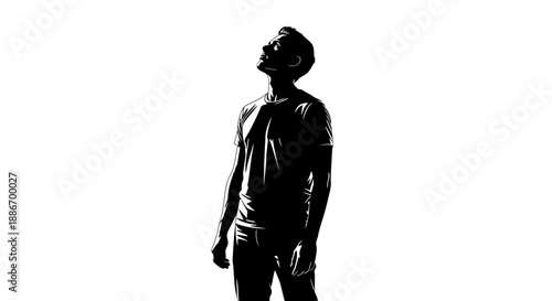Silhouette of a young man looking up with hope, light and shadow contrast