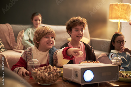 Cuadro en lienzo Group of Caucasian and Asian children and teenagers watching movie together at h