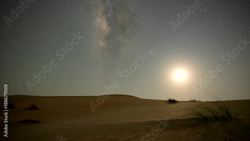 Timelapse of the night sky transition from moonset to dark sky with Milky Way motion in the desert sand dune.  