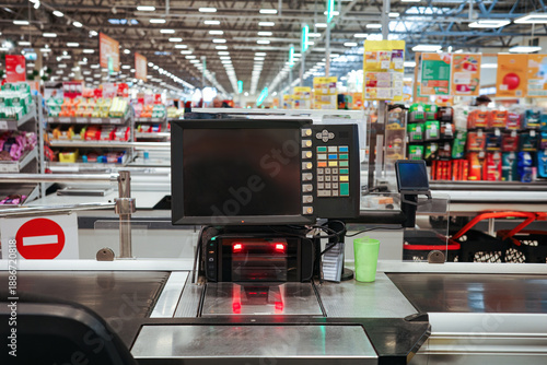 Foto Modern supermarket checkout terminal with screen, barcode scanner, red light, an