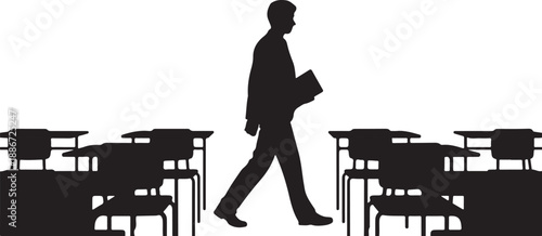Silhouette of a person walking between desks in a classroom