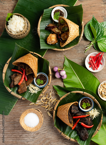 Traditional Lao Food Set Served in Bamboo Baskets on Banana Leaves