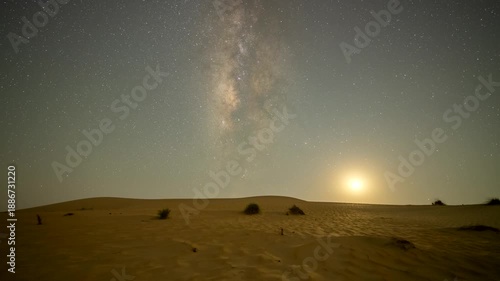 Stunning 4k timelapse of the night sky transition of moonset and Milky Way galaxy motion in the desert sand dune.  stars scape in a remote wilderness location