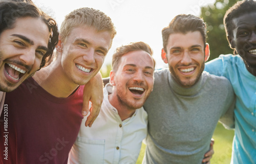 Quadro su tela Happy male friends having fun together outdoor - Group of multiracial men huggin