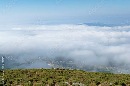 View from the mountain with the city under clouds. Alto da Groba - Baiona - Spain