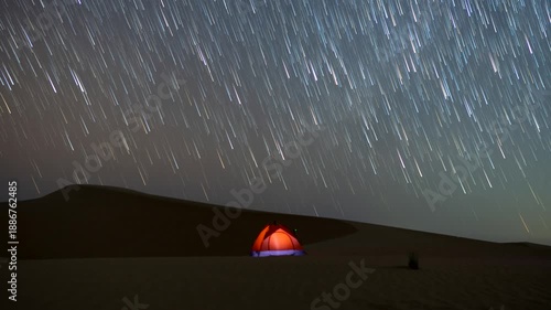 Stunning 4k timelapse of the night sky star tail motion in the desert sand dune.  stars scape in a remote wilderness location.