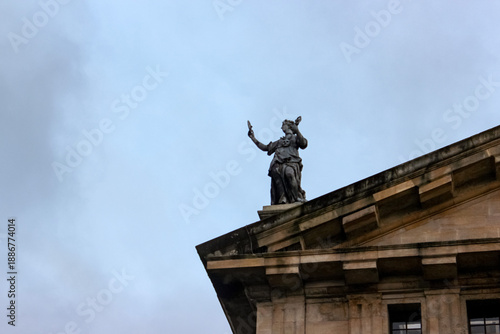 One of nine Muses that adorn the roof of the Clarendon Building in Oxford. The specific statue is believed to be a replica of Euterpe, the Muse of music and lyric poetry.