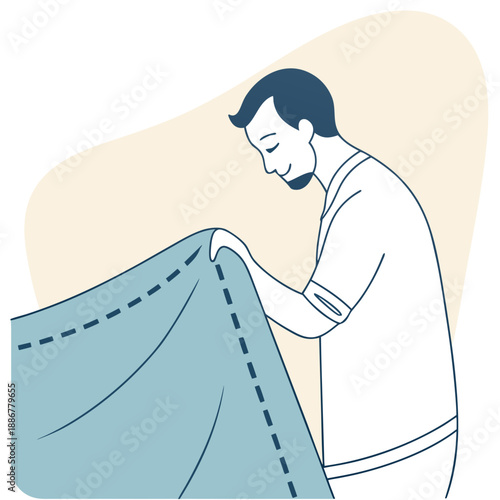 Man folding a blue blanket while smiling in a light background  