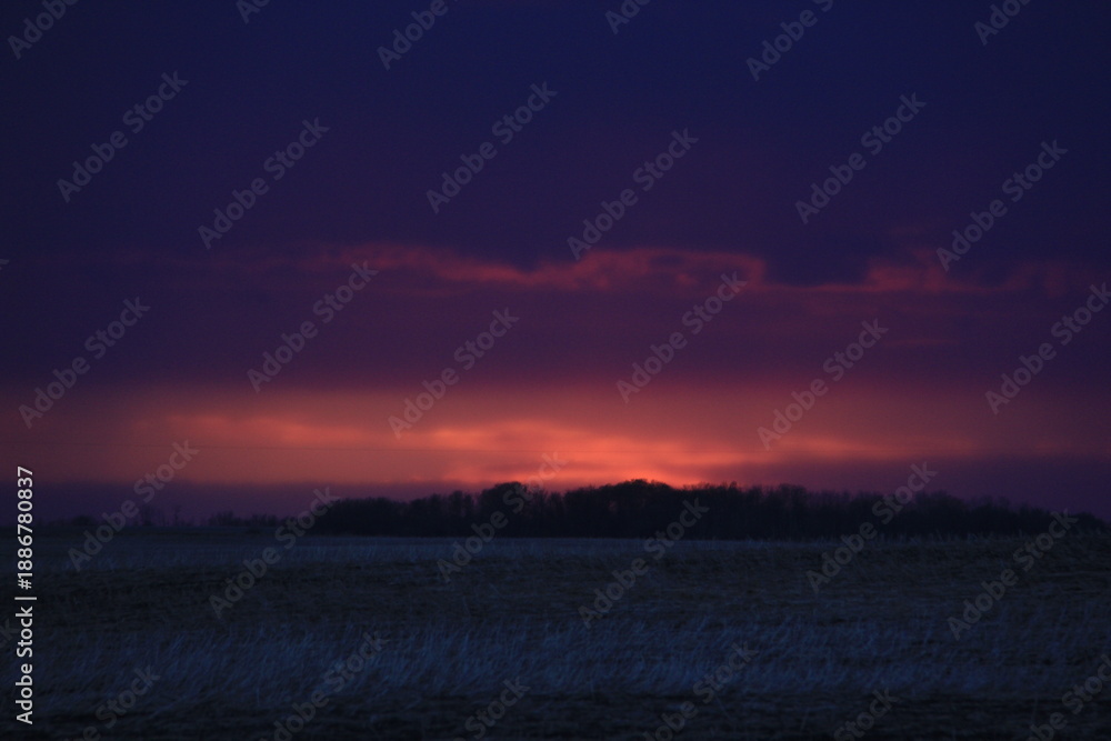 Obraz premium A Prairie storm clouds and setting sun. 