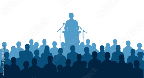 Silhouette of a speaker addressing a large crowd of people from a podium with microphones.