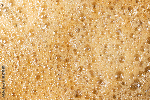 Obraz na plátně Abstract background of espresso crema with air bubbles close-up