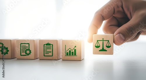 Sustainable business and legal ethics concept with wooden blocks showing icons for growth, management and the scales of justice for corporate compliance.