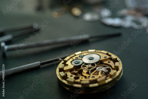 Closeup image of a watchmaker's workshop with dissembled watches and tools