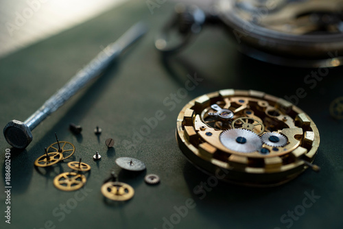 Closeup image of a watchmaker's workshop with dissembled watches and tools