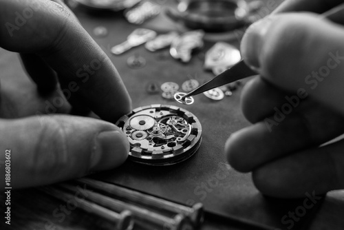 Closeup image of a watchmaker's workshop with dissembled watches and tools