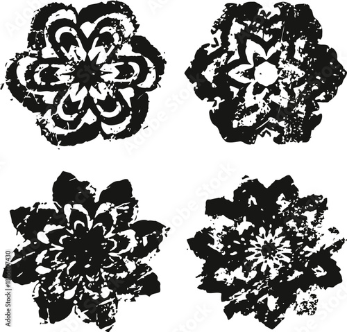 Four black grunge floral shapes with distressed textures and irregular petal designs