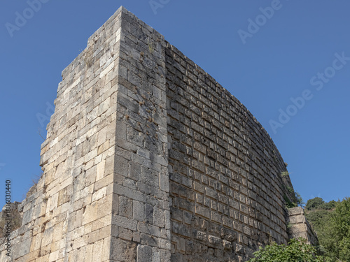 Ruins of the amphitheater in the city of Perge. An ancient city located in Turkey. The walls of the amphitheater in the ancient city are made of huge stone blocks. Masonry of ancient buildings.