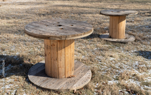 Εκτύπωση καμβά Side view of a large wooden cable spool or timber reel on a grassy field for pow