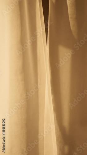 aesthetic vertical video of sheer white curtains moving slowly in soft morning light, gentle shadows, warm neutral tones