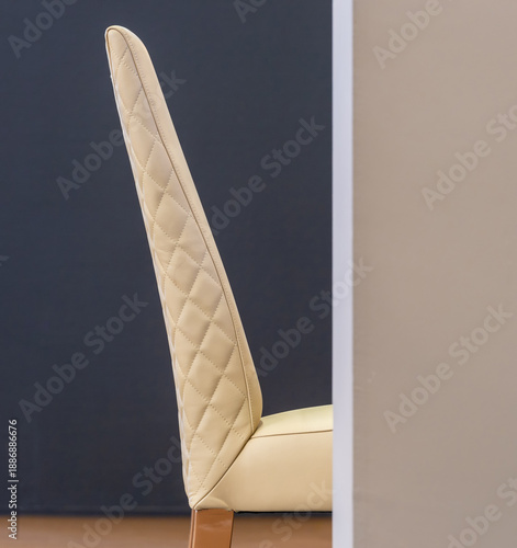 Sleek side profile of upholstered chair in contemporary space