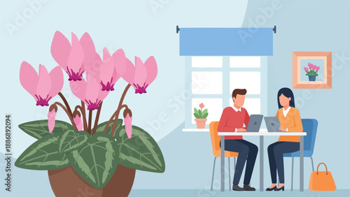 Two people work on laptops at a table next to a window with a plant